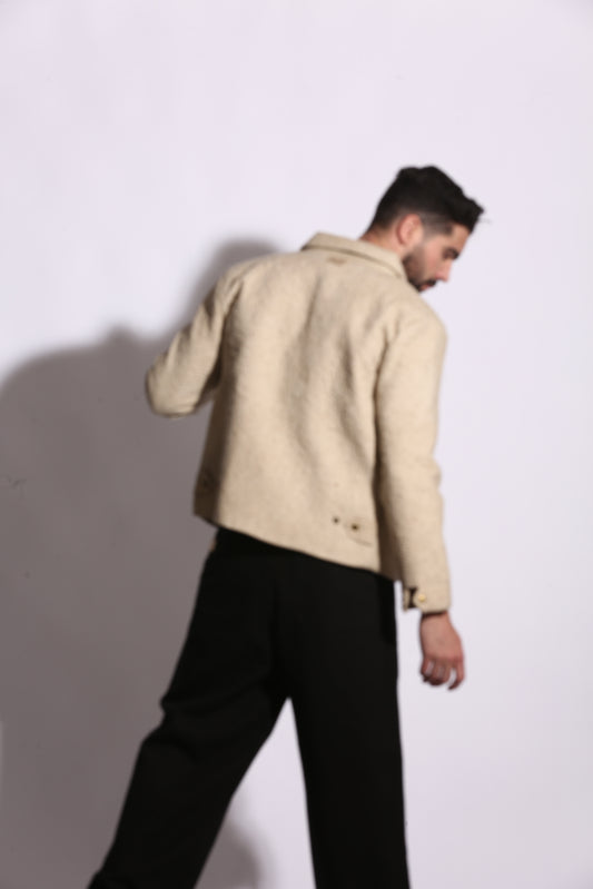 Person wearing a beige coat on a white background