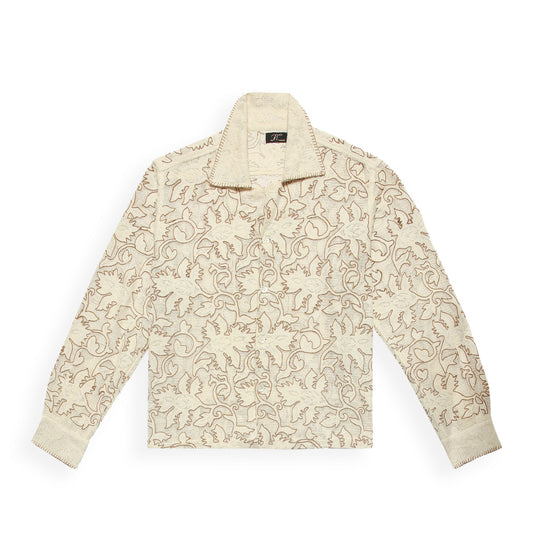 A beige long-sleeved shirt with floral embroidery, crafted from sheer cotton jacquard lace fabric.