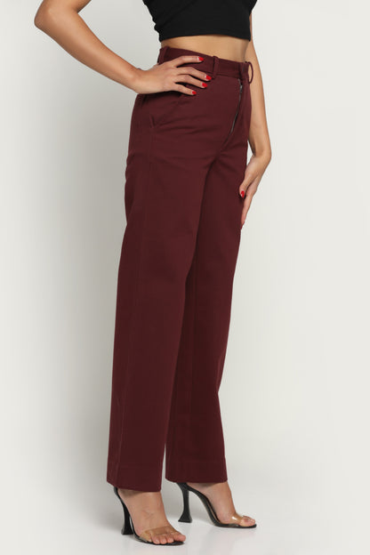 Maroon pants worn by a person on a white background