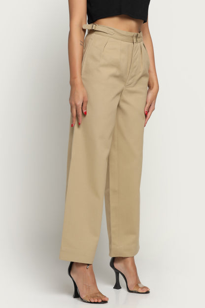 Beige pants worn by a person on a white background