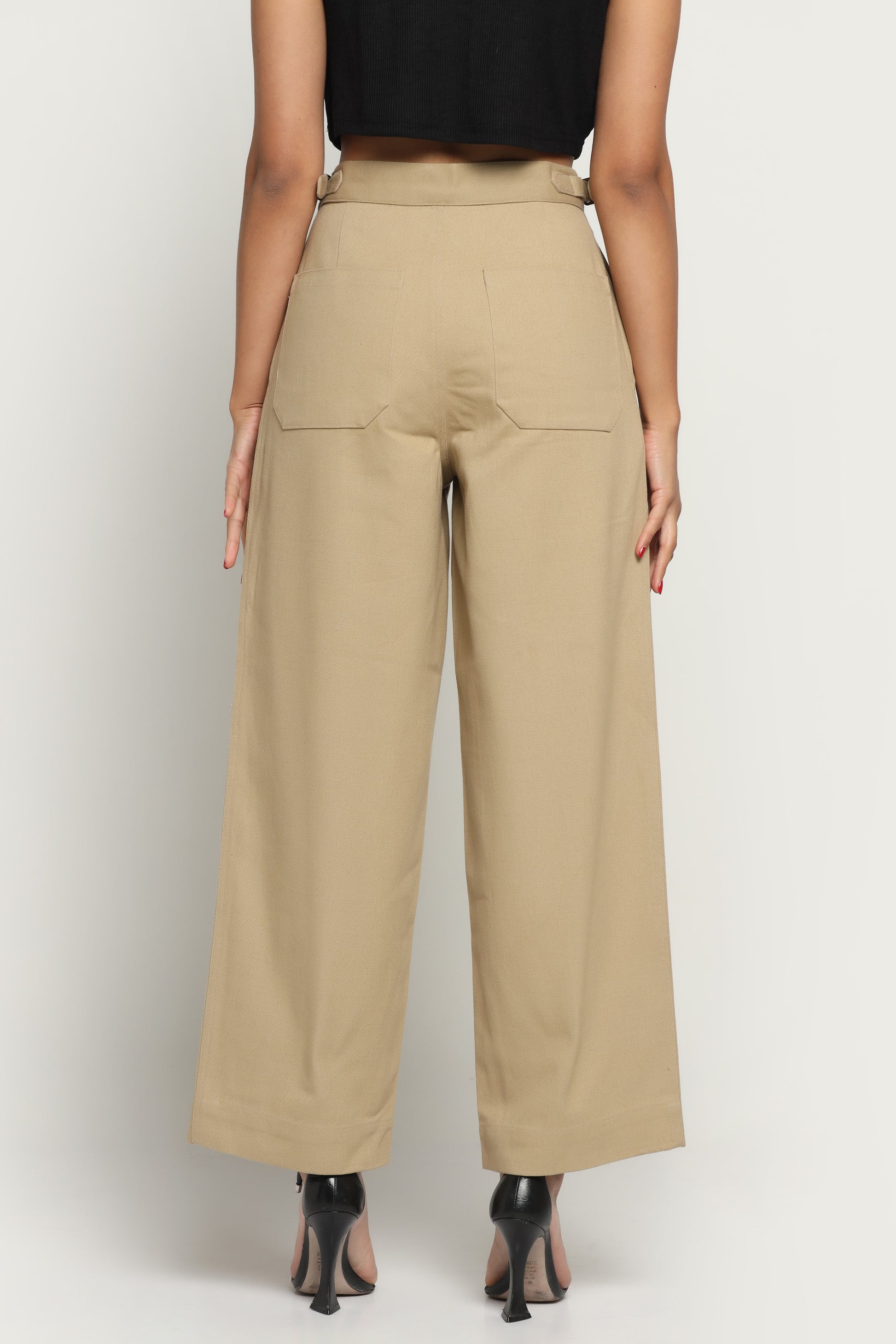 Beige wide-leg pants worn by a person on a white background