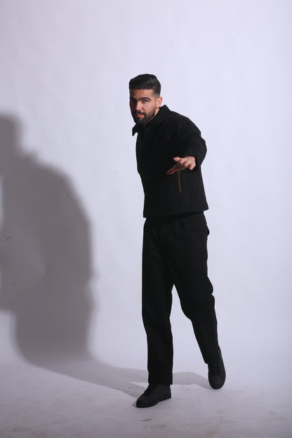 Person wearing a black outfit on a white background