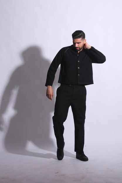Person wearing a black suit on a white background