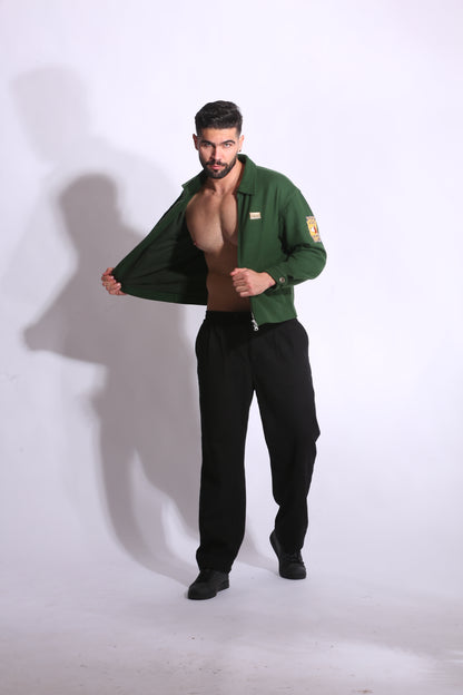 Man wearing a green shirt and black pants on a white background