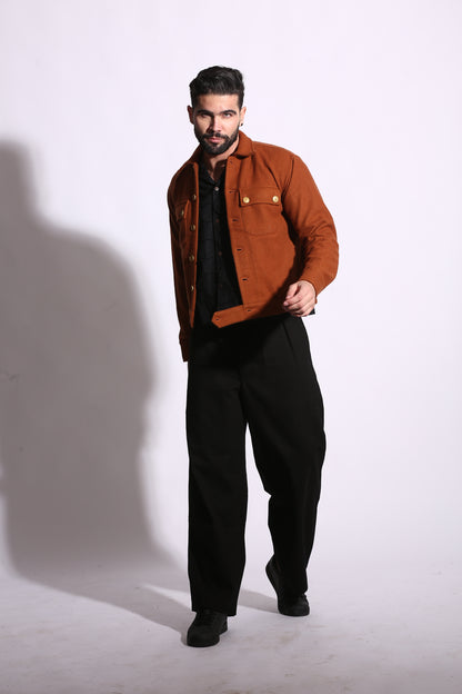 Man wearing a brown jacket and black pants on a white background