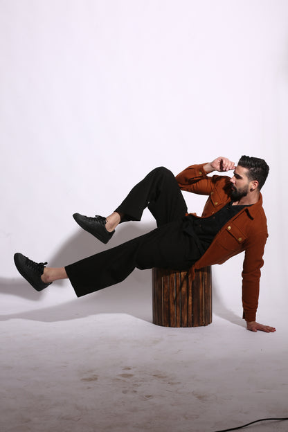 Two people in suits, one standing and one sitting on a wooden block against a white background