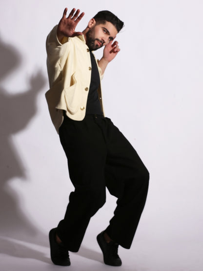 Man in a white shirt and black pants posing against a white background