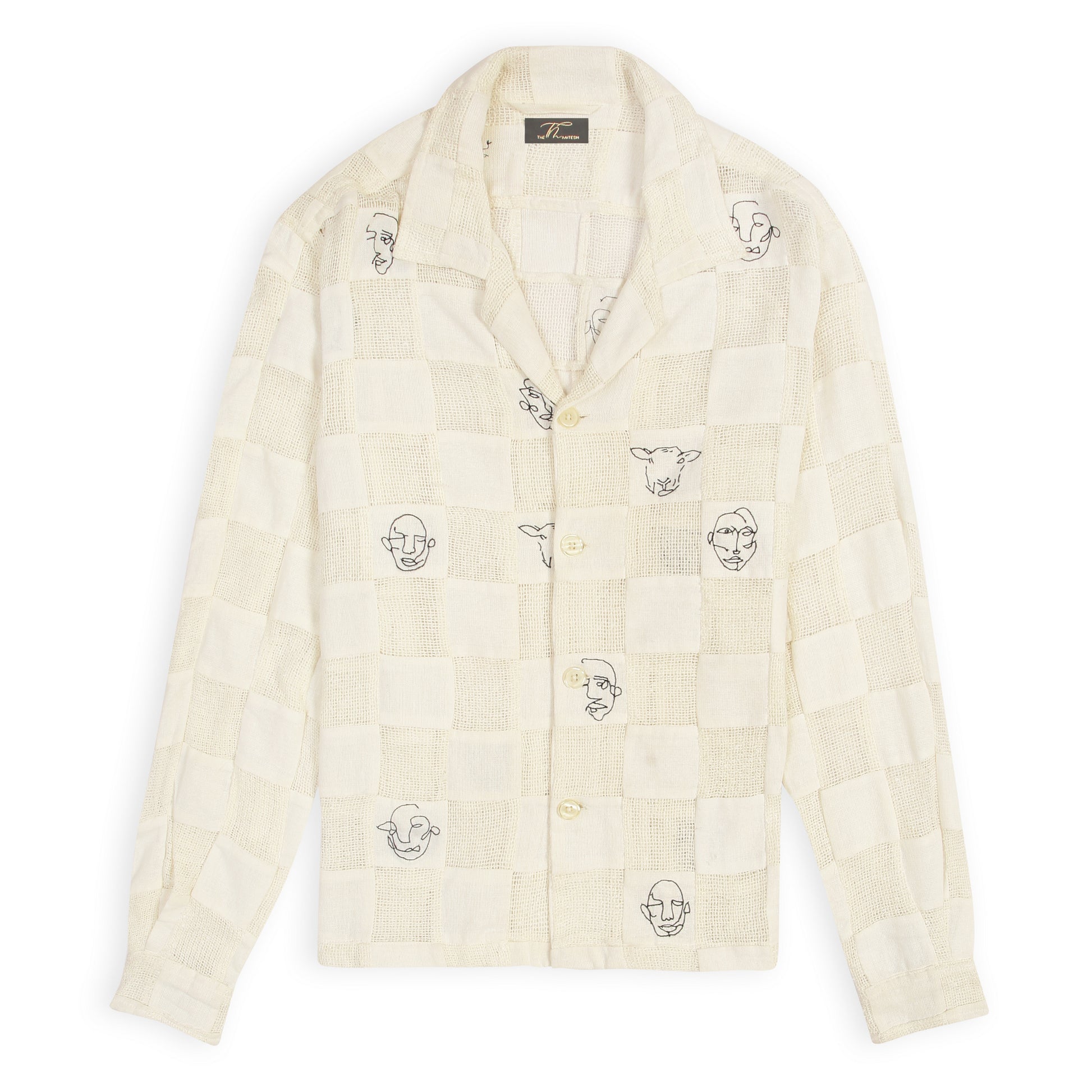 An off-white patchwork shirt with artistic face doodles on a casual collar and sleeve design.
