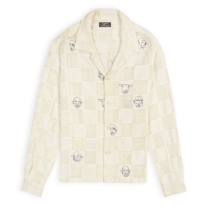 An off-white patchwork shirt with artistic face doodles on a casual collar and sleeve design.