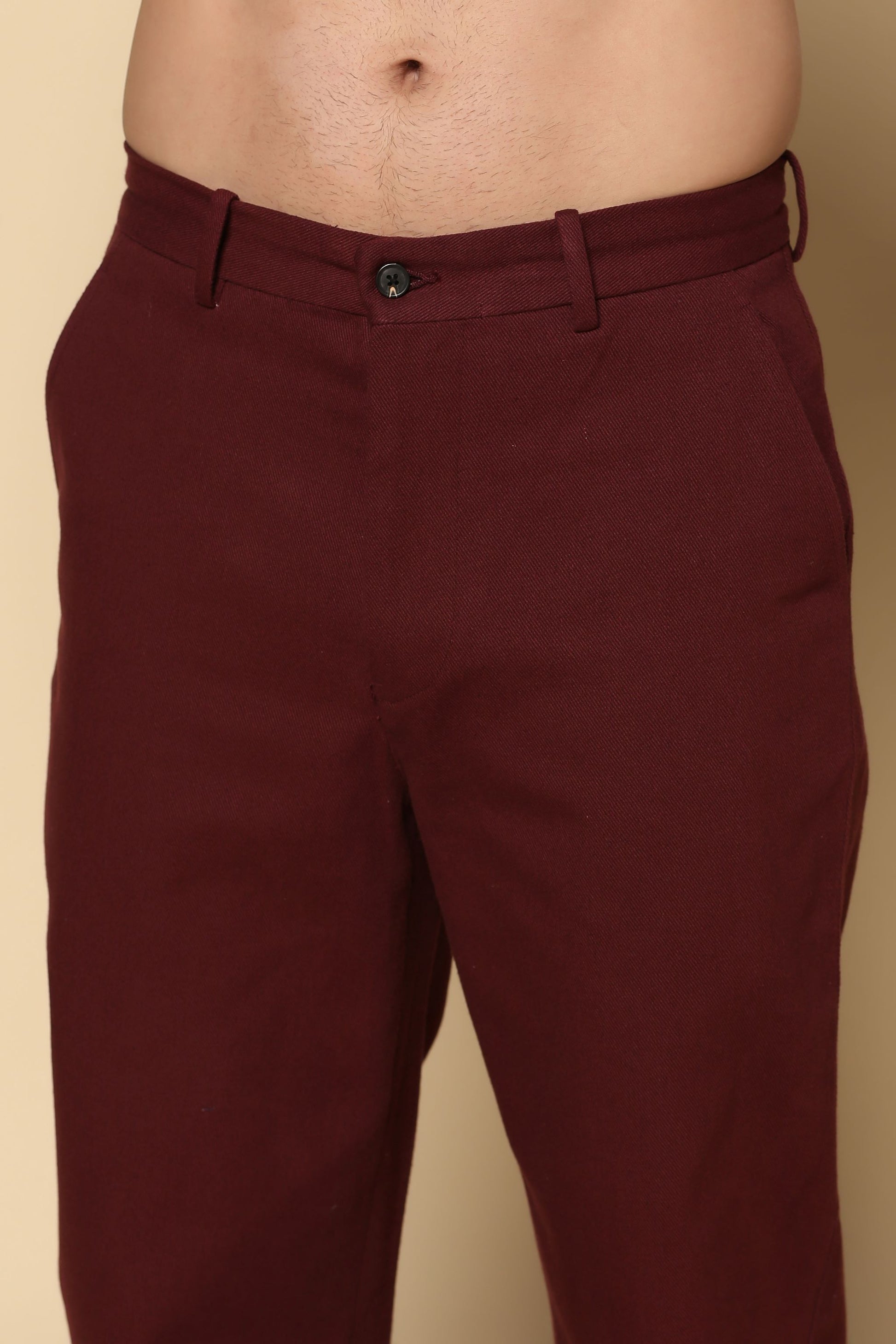 Maroon pants on a beige background