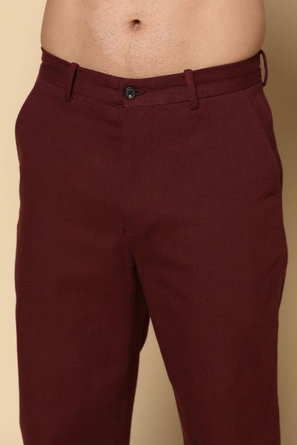 Maroon pants on a beige background