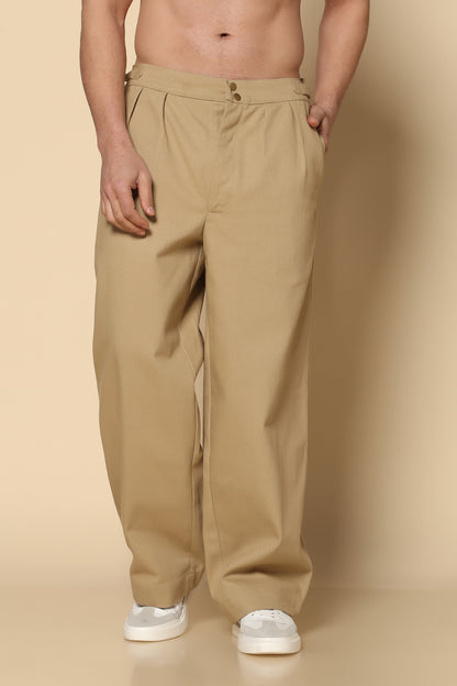 Beige pants worn by a person on a beige background