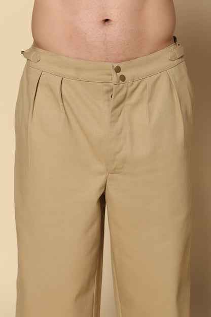 Beige pants worn by a person on a beige background