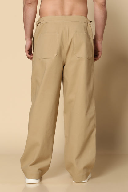 Beige pants worn by a person on a beige background