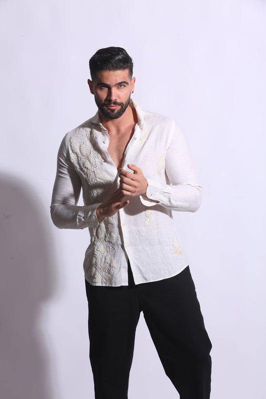 Maglia Chic white linen top; features embroideries on the front with lace + hip stitching 